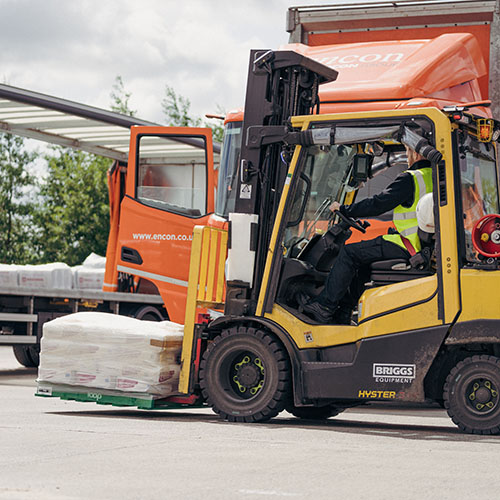 Encon operative loading a waiting vehicle using a forklift truck
