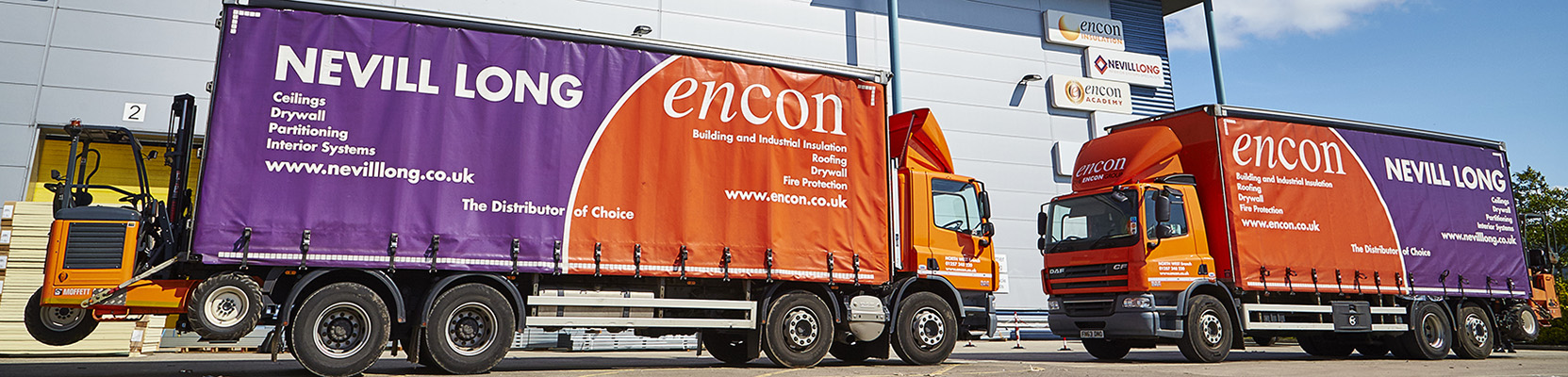 Encon and Nevill Long trucks outside a warehouse